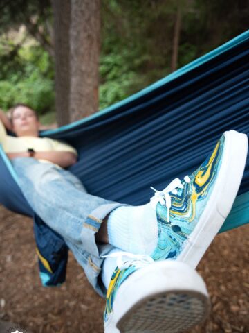 man wearing vans shoes in hammock